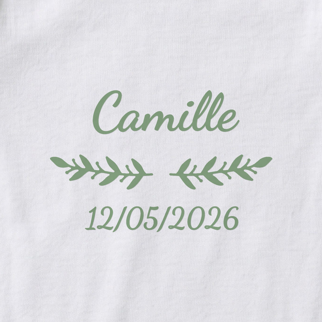 Body bébé personnalisé Camille — gros plan du marquage « Camille », ornement Rameaux et date de naissance « 12/05/2026 »
