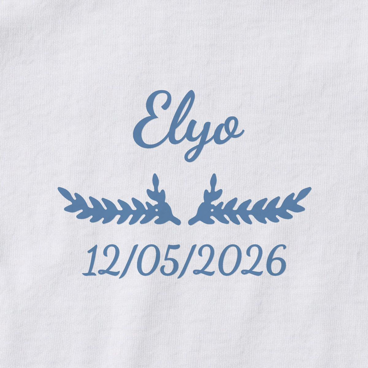 Body bébé personnalisé Elyo — gros plan du marquage « Elyo », ornement Bouquet et date de naissance « 12/05/2026 »