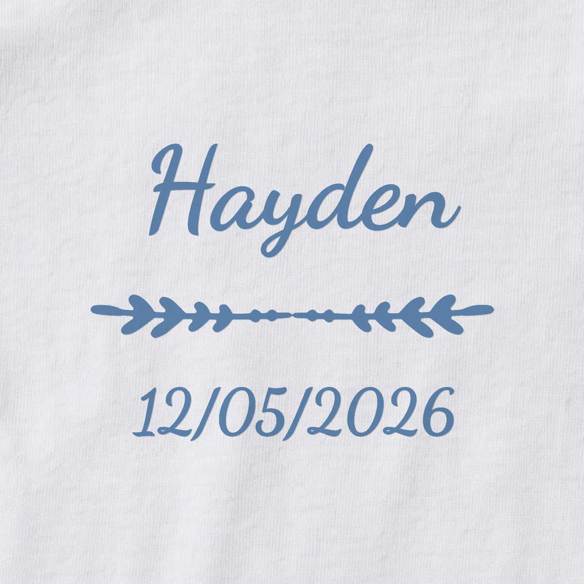 Body bébé personnalisé Hayden — gros plan du marquage « Hayden », ornement Flèche et date de naissance « 12/05/2026 »