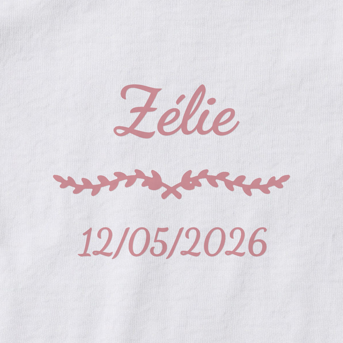 Body bébé personnalisé Zélie — gros plan du marquage « Zélie », ornement Liane et date de naissance « 12/05/2026 »