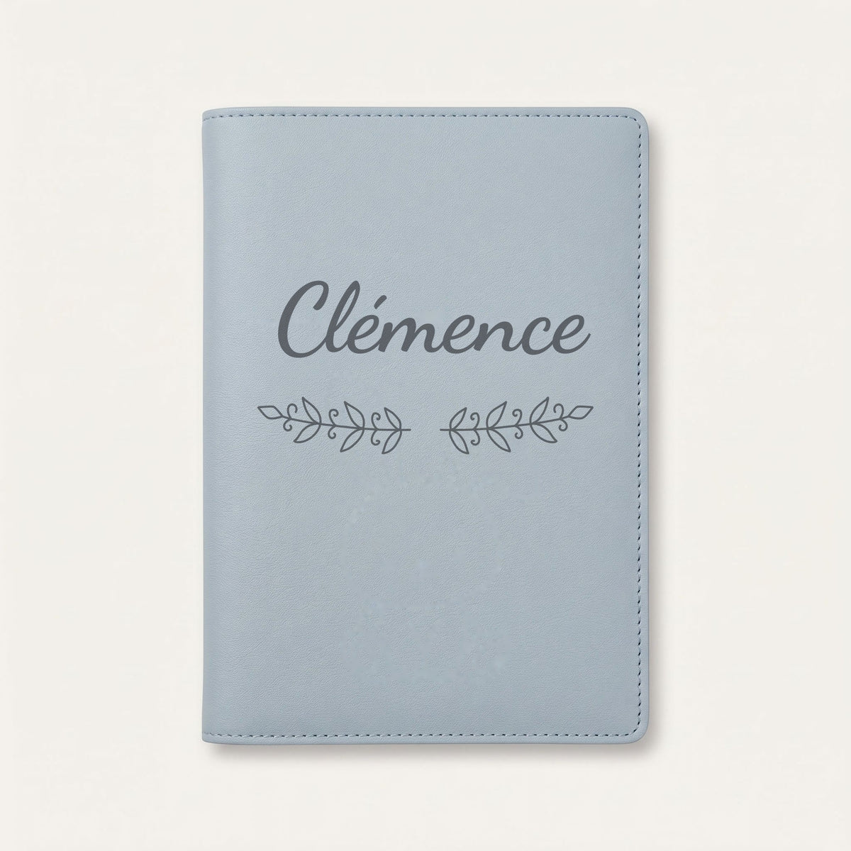 Protège carnet de santé personnalisé Clémence — Bleu nuage — prénom « Clémence » gravé, ornement Volutes