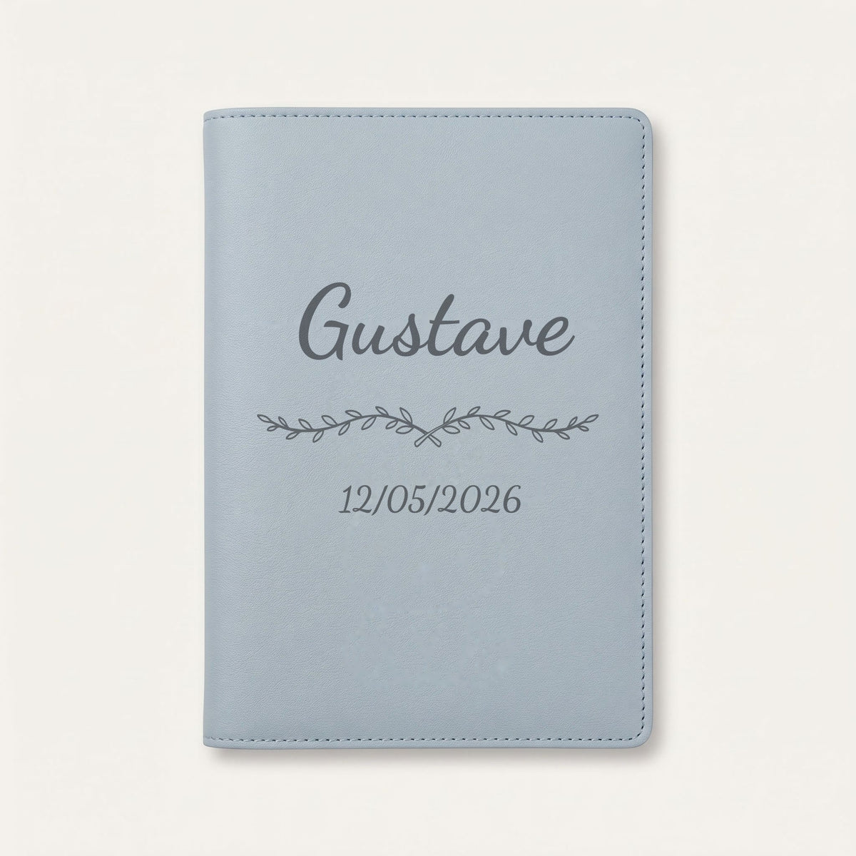 Protège carnet de santé personnalisé Gustave — Bleu nuage — prénom « Gustave », ornement Liane et date de naissance « 12/05/2026 » gravés